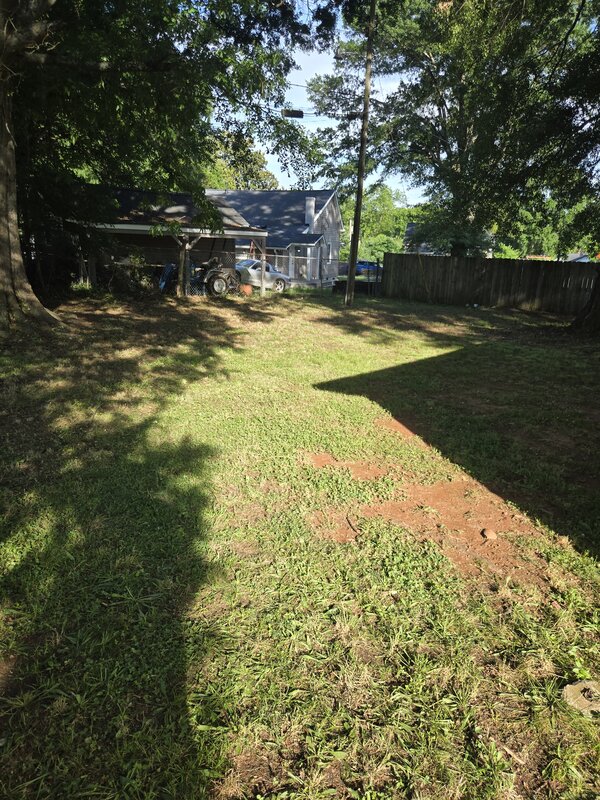 Wide backyard showing clean mow lines after LawnSkapers service