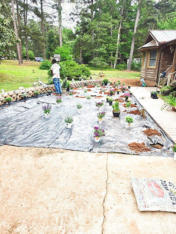 LawnSkapers crew member working a landscape project at a customer home